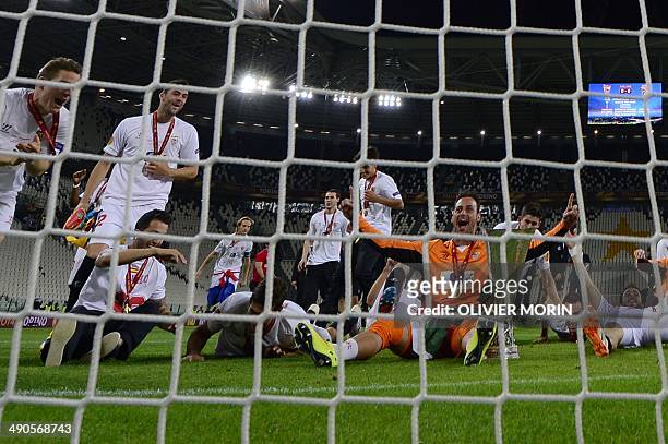 Sevilla's Portuguese goalkeeper Beto celebrates with the trophy after winning the UEFA Europa league final football match between Benfica and Sevilla...
