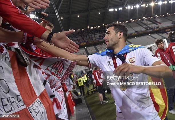 Sevilla's midfielder Vicente Iborra de la Fuente celebrates with fans after winning the UEFA Europa league final football match between Benfica and...
