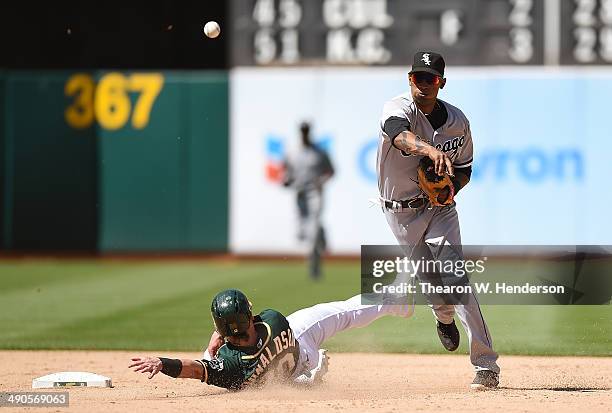 Alexei Ramirez of the Chicago White Sox completes the double-play over the top of Josh Donaldson of the Oakland Athletics in the bottom of the ninth...