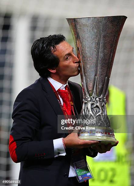 Head Coach Unai Emery of Sevilla kisses the Europa league trophy during the UEFA Europa League Final match between Sevilla FC and SL Benfica at...