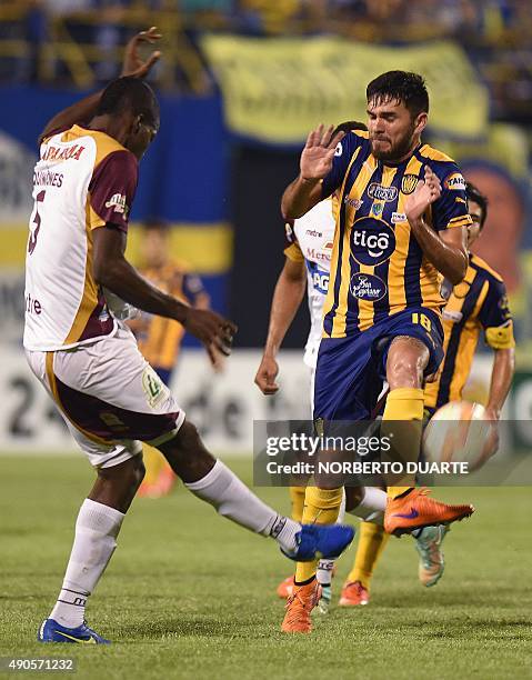Footballer Julian Quinonez of Colombia's team Deportes Tolima and Jorge Ortega of Paraguay's Sportivo Luqueno vie for the ball during a Sudamericana...