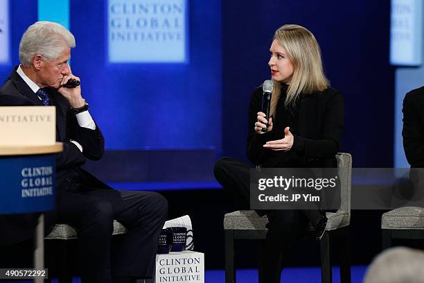 Elizabeth Holmes speaks as former U.S. President Bill Clinton listens during the closing session of the Clinton Global Initiative 2015 on September...