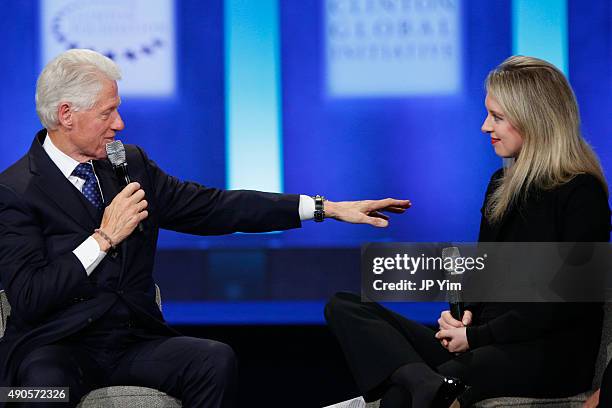 President Bill Clinton speaks as Elizabeth Holmes, founder and CEO of Theranos listens during the closing session of the Clinton Global Initiative...