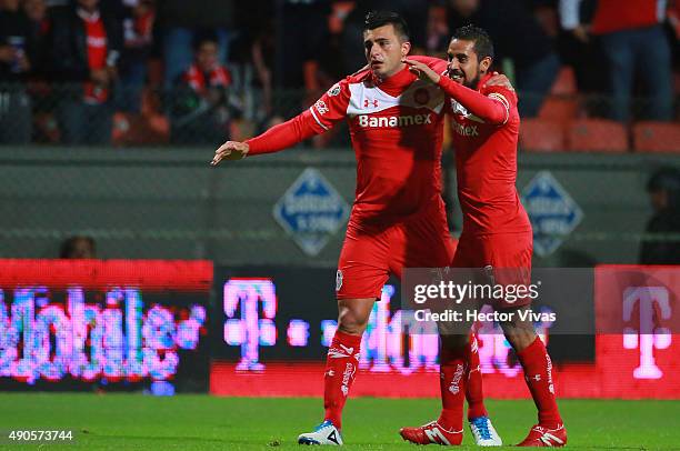 Enrique Triverio of Toluca celebrates with Oscar Ricardo Rojas after scoring the first goal of his team during the 11th round match between Toluca...