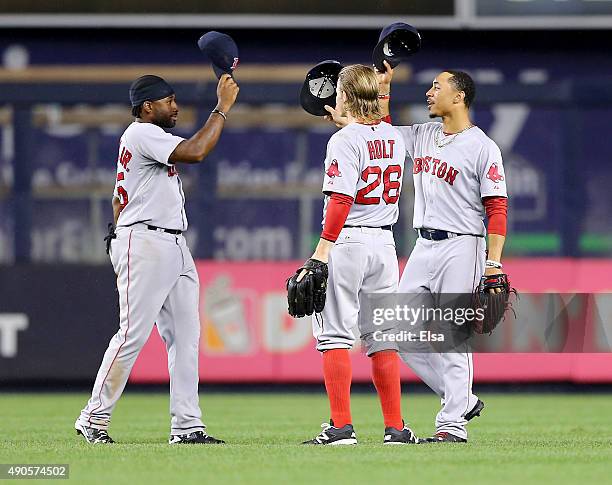 Jackie Bradley Jr. #25,Brock Holt and Mookie Betts of the Boston Red Sox celebrate the win over the New York Yankees on September 29, 2015 at Yankee...