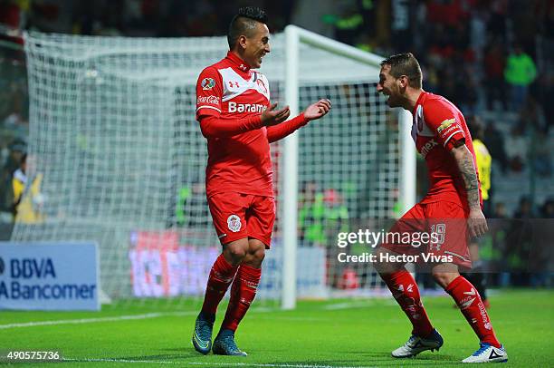 Christian Cueva of Toluca celebrates with Dario Botinelli after scoring the second goal of his team during the 11th round match between Toluca and...