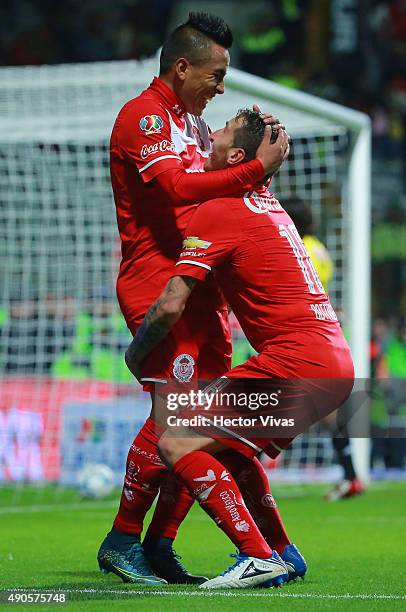 Christian Cueva of Toluca celebrates with Dario Botinelli after scoring the second goal of his team during the 11th round match between Toluca and...