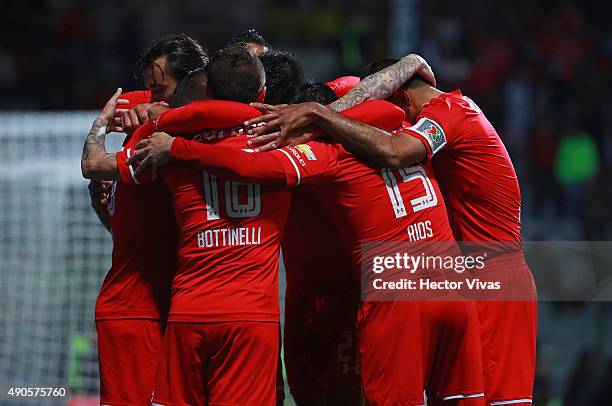 Christian Cueva of Toluca celebrates with teammates after scoring the second goal of his team during the 11th round match between Toluca and Tijuana...