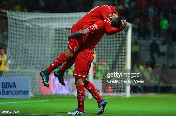 Christian Cueva of Toluca celebrates with Dario Botinelli after scoring the second goal of his team during the 11th round match between Toluca and...