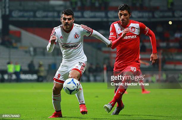 Jordan Silva of Toluca struggles for the ball with Alfredo Moreno of Tijuana during the 11th round match between Toluca and Tijuana as part of the...