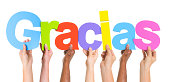Multiethnic Group of Hands Holding Word Gracias