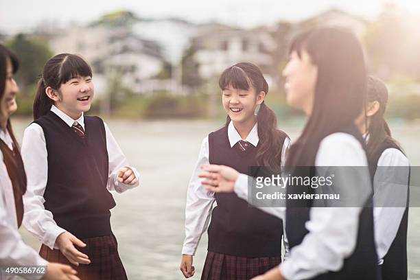 japanese students girls talking in the schoolyard - japan 12 years girl stock pictures, royalty-free photos & images