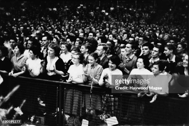 Audience members at the Royal Albert Hall in London, during the Last Night of the Proms, September 1952. Original Publication : Picture Post - 6059 -...