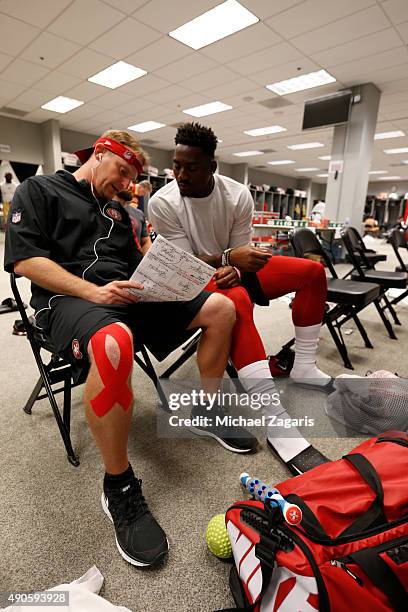 Linebackers Coach Jason Tarver of the San Francisco 49ers talks with Eli Harold in the locker room prior to the game against the Arizona Cardinals at...