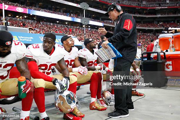 Defensive Coordinator Eric Mangini of the San Francisco 49ers takes with Eric Reid on the sideline during the game against the Arizona Cardinals at...