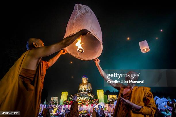 Buddhist monks release a lantern into the air at Borobudur temple during celebrations for Vesak Day on May 15, 2014 in Magelang, Central Java,...