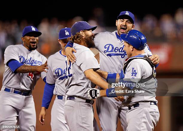 Clayton Kershaw, Adrian Gonzalez and A.J. Ellis of the Los Angeles Dodgersn celebrate after they beat the San Francisco Giants to clinch the National...