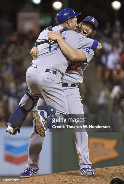 Clayton Kershaw and A.J. Ellis of the Los Angeles Dodgers celebrates defeating the San Francisco Giants 8-0 to clinch the National League West at...