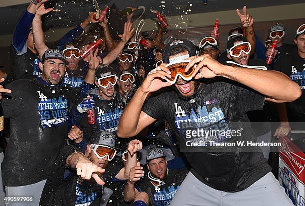 The Los Angeles Dodgers celebrates in the locker room with champagne and beer after they defeated the San Francisco Giants 8-0 to clinch the National...