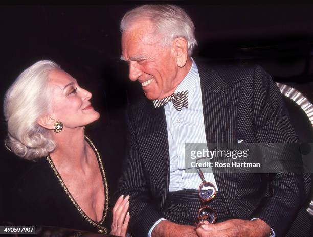 Model Carmen Dell'Orefice and the photographer Horst P Horst attend a book party for the latter held at Henri Bendel, New York, New York, late 1980s.