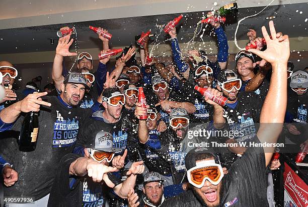 The Los Angeles Dodgers celebrates in the locker room with champagne and beer after they defeated the San Francisco Giants 8-0 to clinch the National...