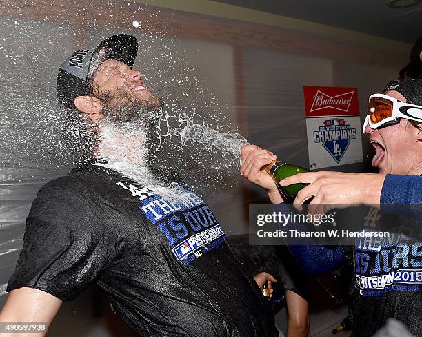 Clayton Kershaw of the Los Angeles Dodgers is sprayed with champagne after the Dodgers defeated the San Francisco Giants 8-0 to clinch the National...