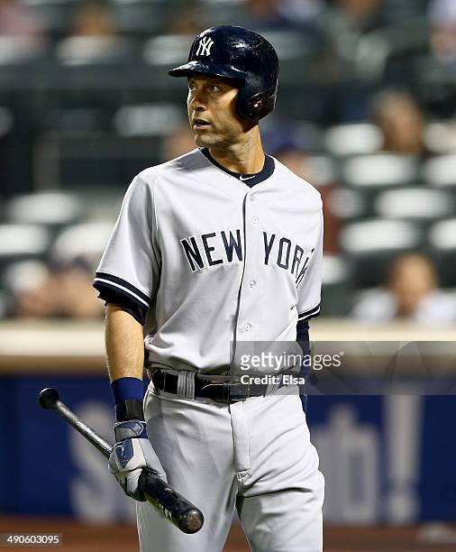 Derek Jeter of the New York Yankees heads back to the dugout after he struck out in the third inning against the New York Mets during interleague...