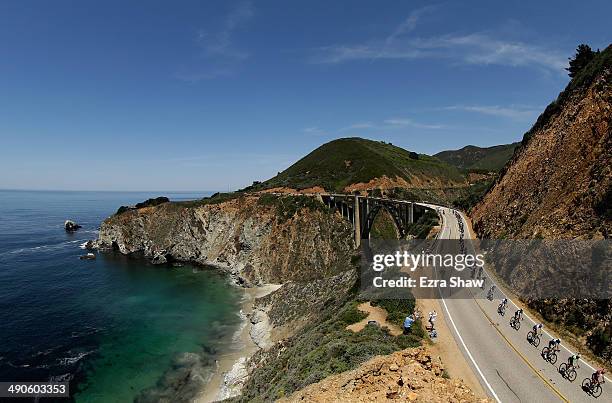 The peloton rides along California Highway 1 just past the Bixby Bridge during stage four of the 2014 Amgen Tour of California from Monterey to...