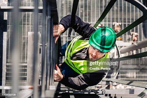 young male technician climbing ladder in industry - worker with hard hat stock pictures, royalty-free photos & images