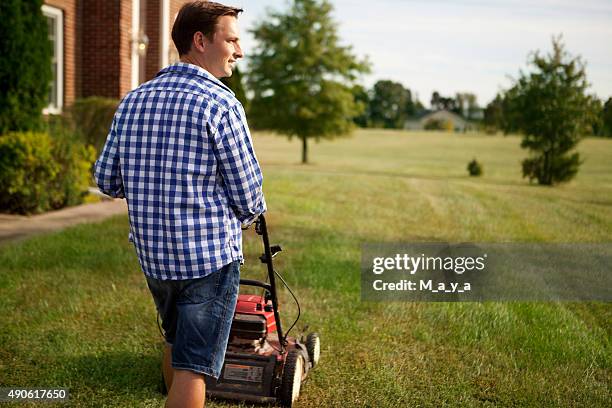 chores around the house - mowing lawn bildbanksfoton och bilder