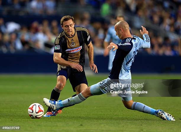 Aurelien Collin of Sporting KC and Andrew Wenger of Philadelphia Union battle for the ball during the game at Sporting Park on May 14, 2014 in Kansas...