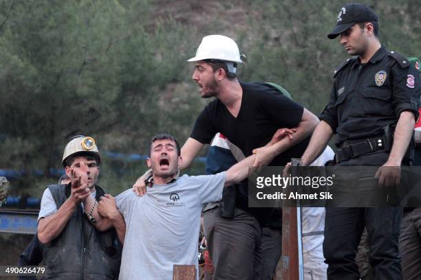 Relatives of the trapped mines react infront of the mine May 15, 2014 in Soma, a district in Turkey's western province of Manisa. An explosion and...