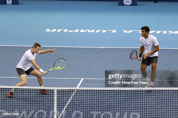 Rameez Junaid of Australia and Jonathan Marray of Great Britain competes against Grigor Dimitrov of Bulgaria and Leander Paes of India during the...