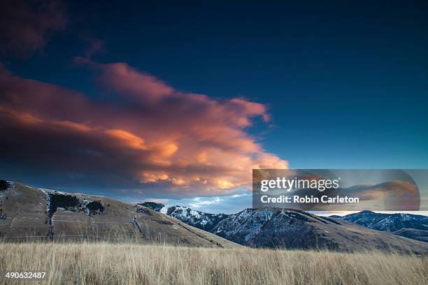 clouds glow pink over mount jumbo and mount sentinal near missoula, montana. - missoula stock pictures, royalty-free photos & images