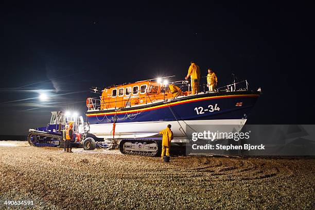Aldeburgh lifeboat is being cleaned under a full moon after returning from a distress call.