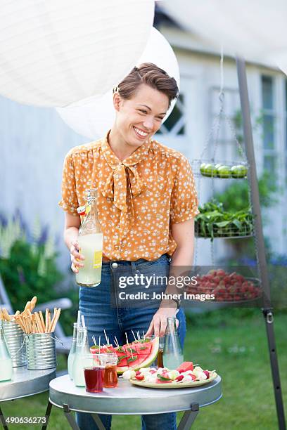 smiling woman with drink at garden party - fest 2013 day 1 stock-fotos und bilder