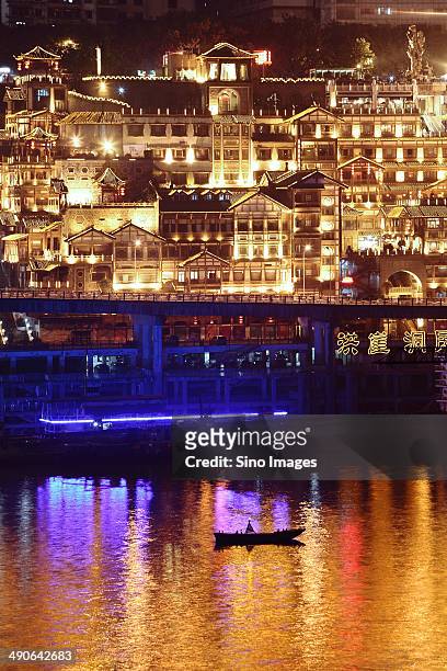 brightly-lit buildings along jialing river in hongya cave - chongqing hongyadong stock pictures, royalty-free photos & images