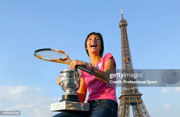 Anastasia Myskina of Russia poses with the trophy in front of the Eiffel Tower after winning her women's final match against Elena Dementieva of...