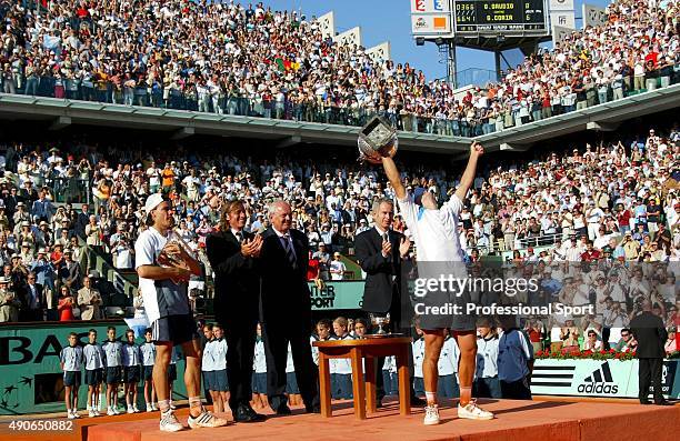 Gaston Gaudio of Argentina celebrates with the trophy after winning his mens final match against Guillermo Coria of Argentina, on Day Fourteen of the...