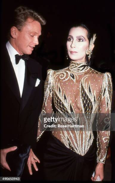 Designer Bob Mackie and the singer and actress Cher attend the Costume Institute Gala at the Metropolitan Museum of Art, New York, New York, 1985.