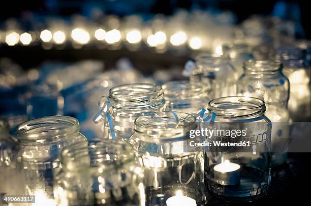 lots of tea lights in jars - tea light stock pictures, royalty-free photos & images