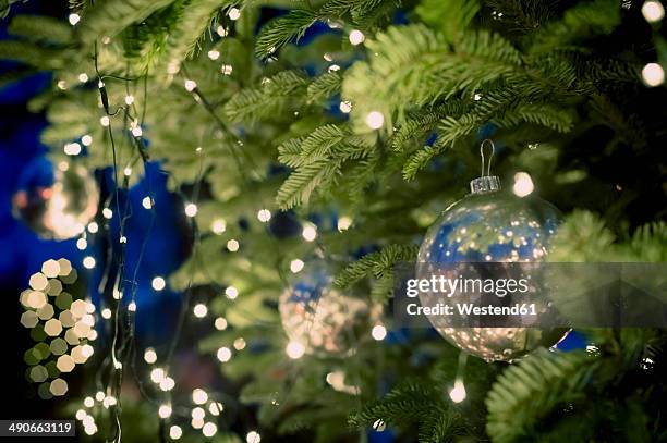 christmas tree with baubles and fairy lights - christmas decoration outdoor stock pictures, royalty-free photos & images