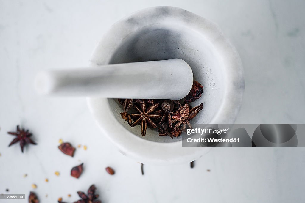 Marble mortar and pestle with star anise (Illicium verum)