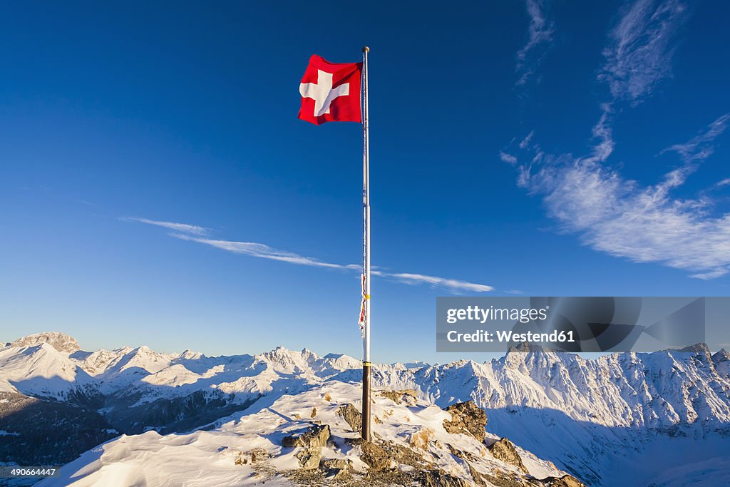 Switzerland, Graubuenden, Savognin, Mountaintop Piz Martegnas, swiss flag