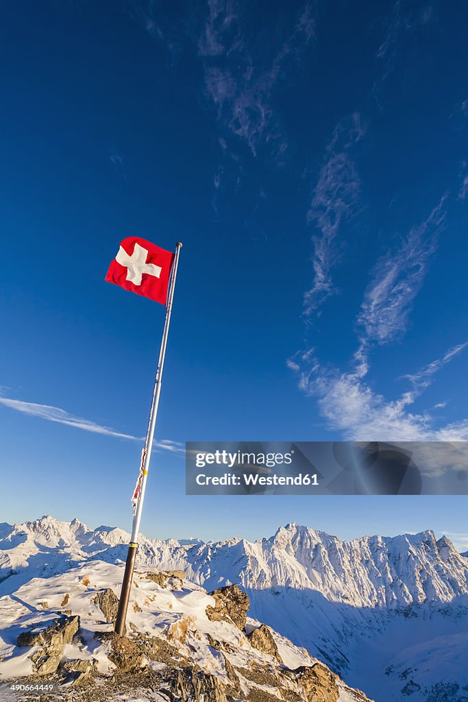 Switzerland, Graubuenden, Savognin, Mountaintop Piz Martegnas, swiss flag