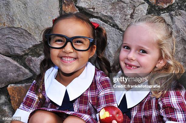 two cute geeky school girls - first day of school australia stock pictures, royalty-free photos & images