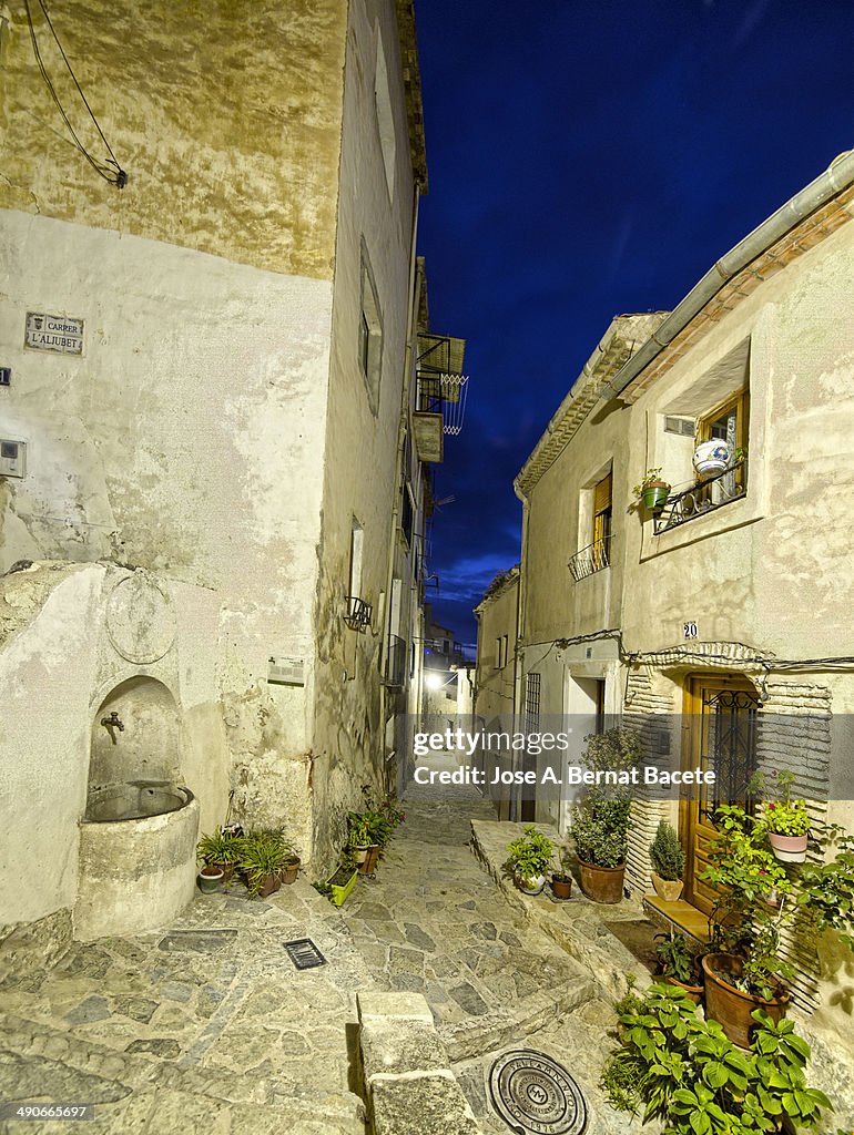 Street of old town and close at dawn with a source