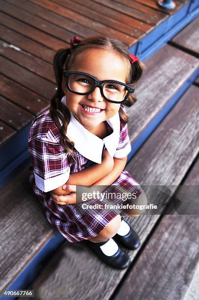 smiling cute geeky girl - first day of school australia stock pictures, royalty-free photos & images