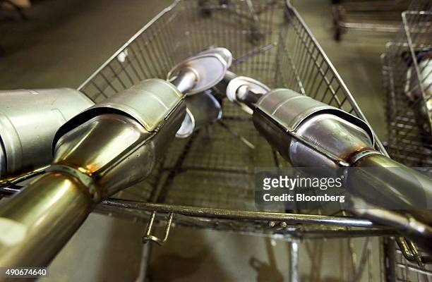 Completed automobile catalytic converter emission control devices sit in a trolley at BM Catalysts in Mansfield, U.K., on Wednesday, Sept. 30, 2015....