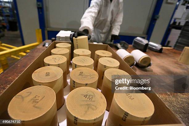 An employee selects a automobile catalytic converter emission control device 'brick' or monolith, that contains platinum, from a tray at BM Catalysts...